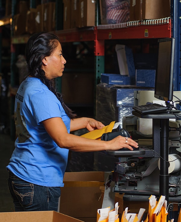 Employee holding up a product showing it sideways to the camera