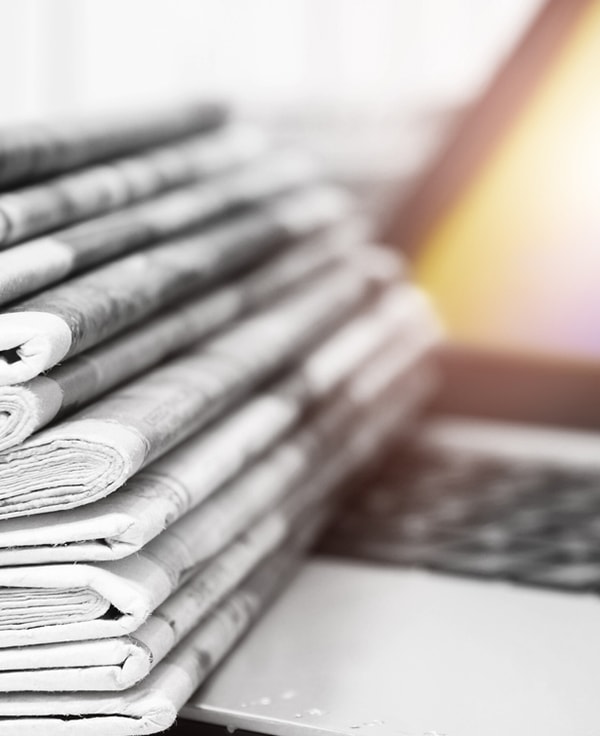 Stacked newspapers on a keyboard