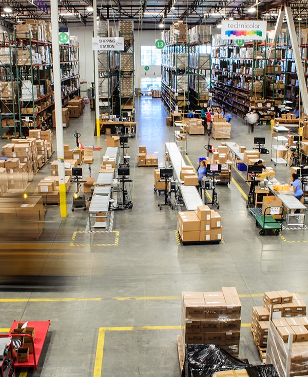 Overhead view of AMS warehouse, including pages and employees working