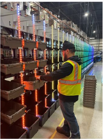 A person organizing shelves with cubbies, illuminated by light strips in various colors. 	