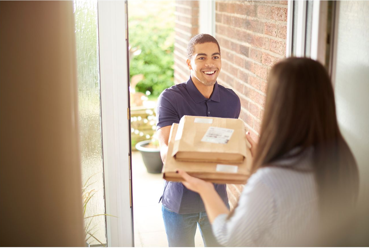 An image of someone delivering packages to a consumer. 