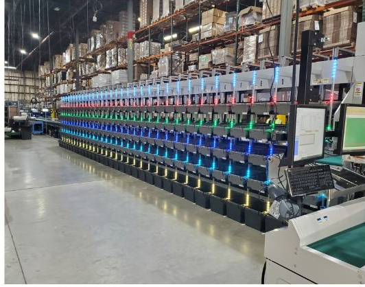 A picture of a shelf full of cubbies, illuminated by light strips in varying colors. 	