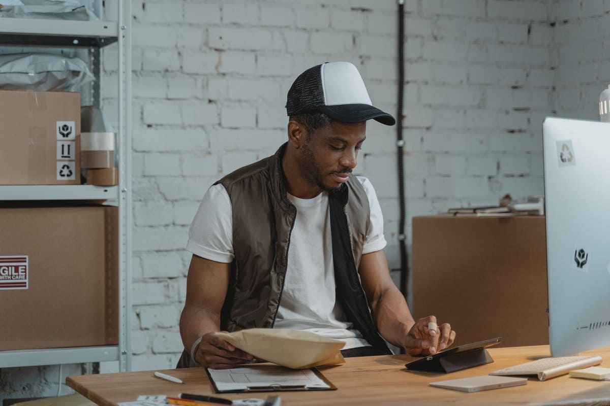 man entering data on a device - AMS Fulfillment