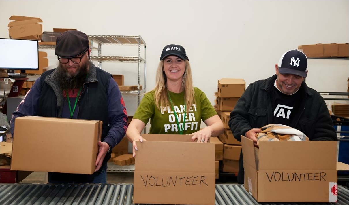 Three AMS employees packing volunteer boxes