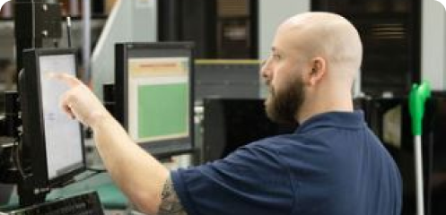 Person looking at a computer monitor.