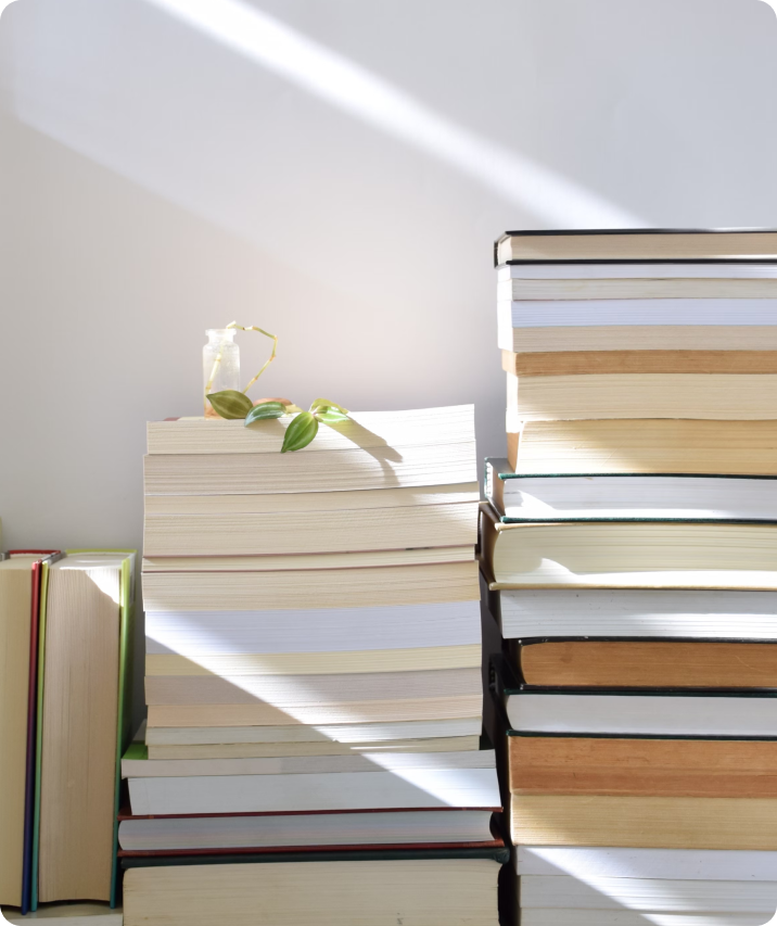 Image of two stacks of books and two vertical books next to them.