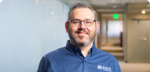 Photo of one of our wonderful employees, wearing a blue polo.