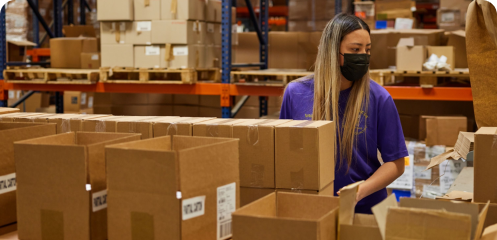 AMS Fulfillment employee filling boxes.