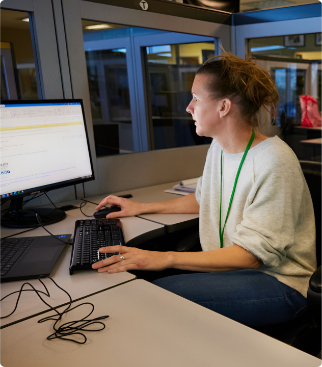 AMS employee working at a computer
