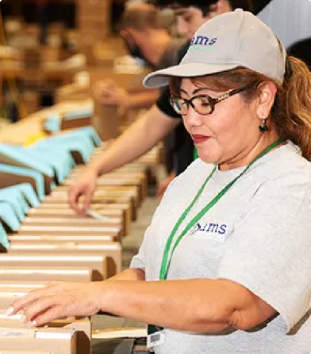 People putting labels on packages, ready to be shipped.