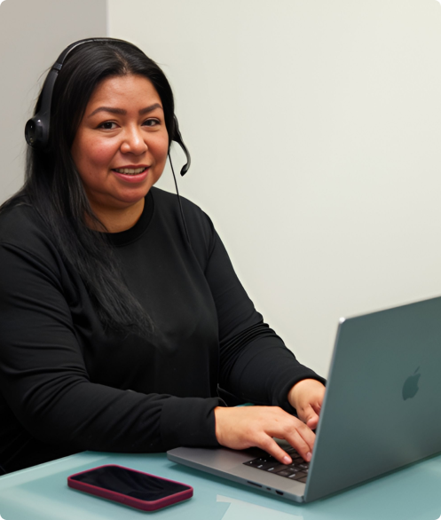 AMS employee offering customer support at a laptop