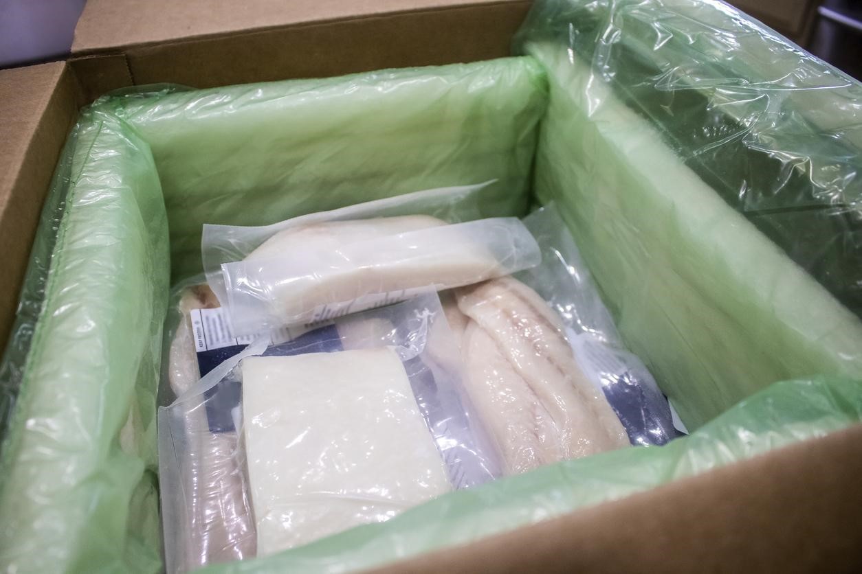 Shipped fish frozen in insolated box styrofoam insolation and dry ice - close-up - AMS Fulfillment