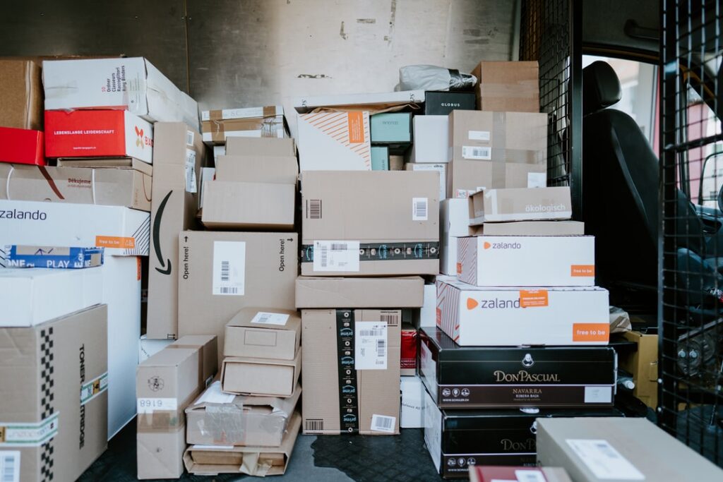 A delivery truck is full of packages from various brands.