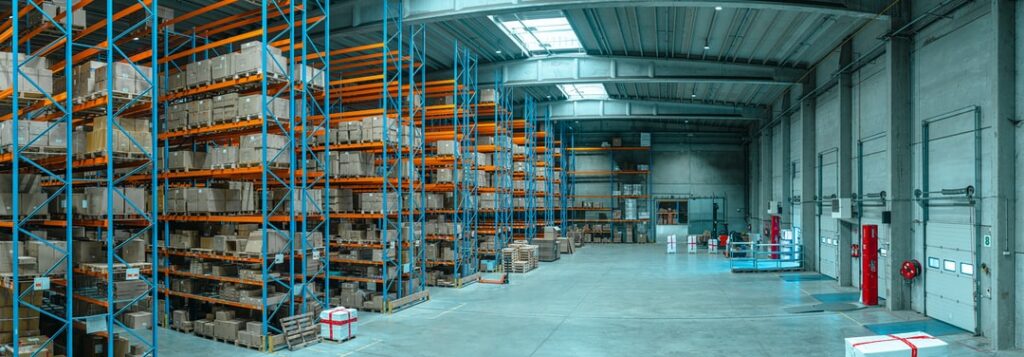 A cold storage facility, with fully stocked shelves on the left, and a closed loading dock on the right.